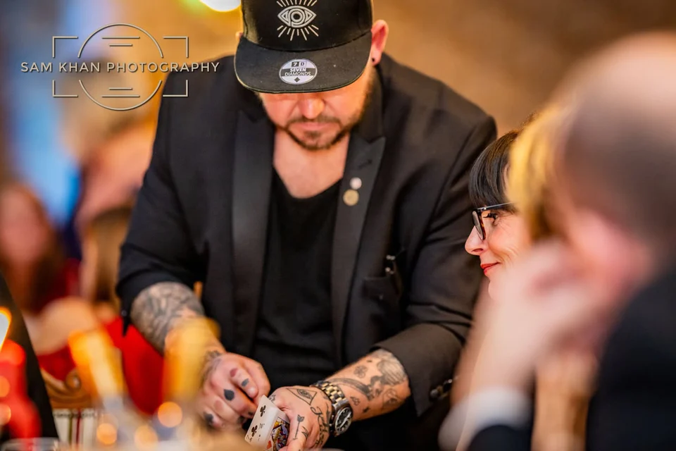 Phil Pearson leaning in while performing close-up magic