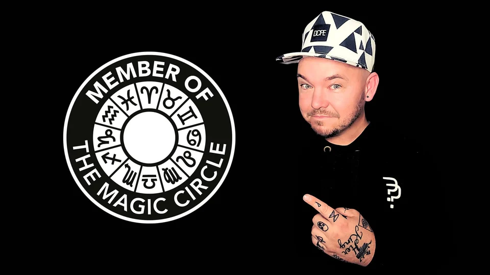 Phil pointing towards The Magic Circle membership logo