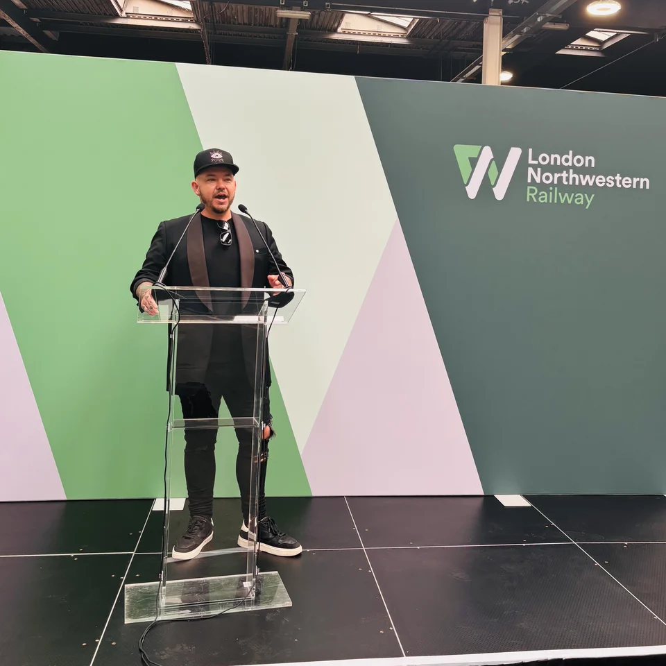 Phil speaking on stage at a corporate event