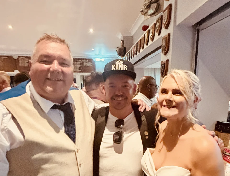 Phil pictured with a bride and groom