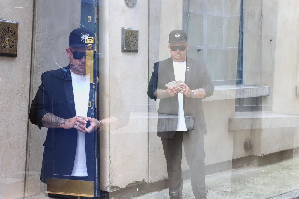 An editorial photograph of Phil and his reflection outside