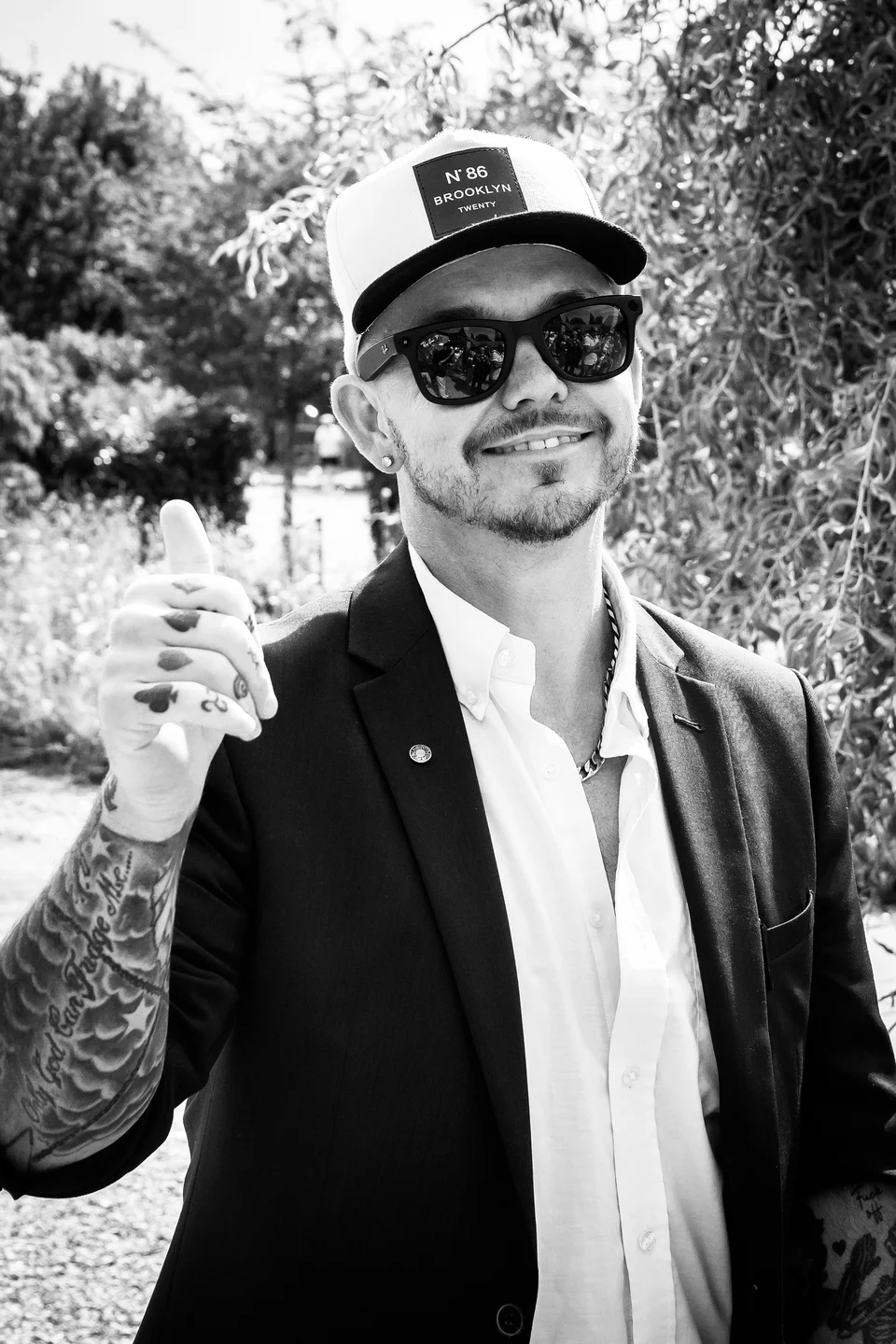 Black and white portrait of Phil in a cap and sunglasses