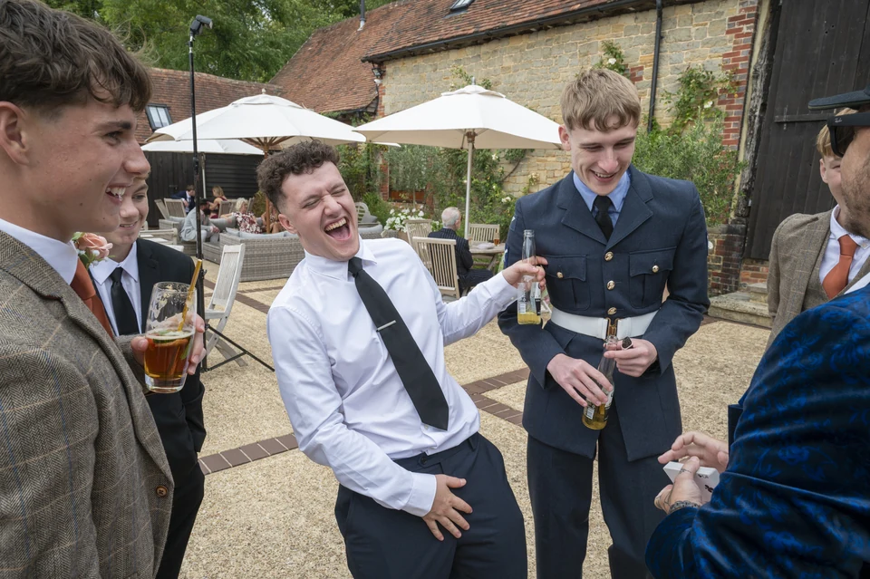 Wedding guests laughing during Phil Pearson’s close-up magic