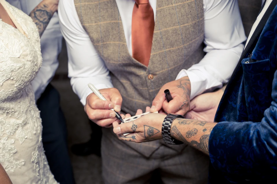 Close-up of a signed playing card during wedding magic