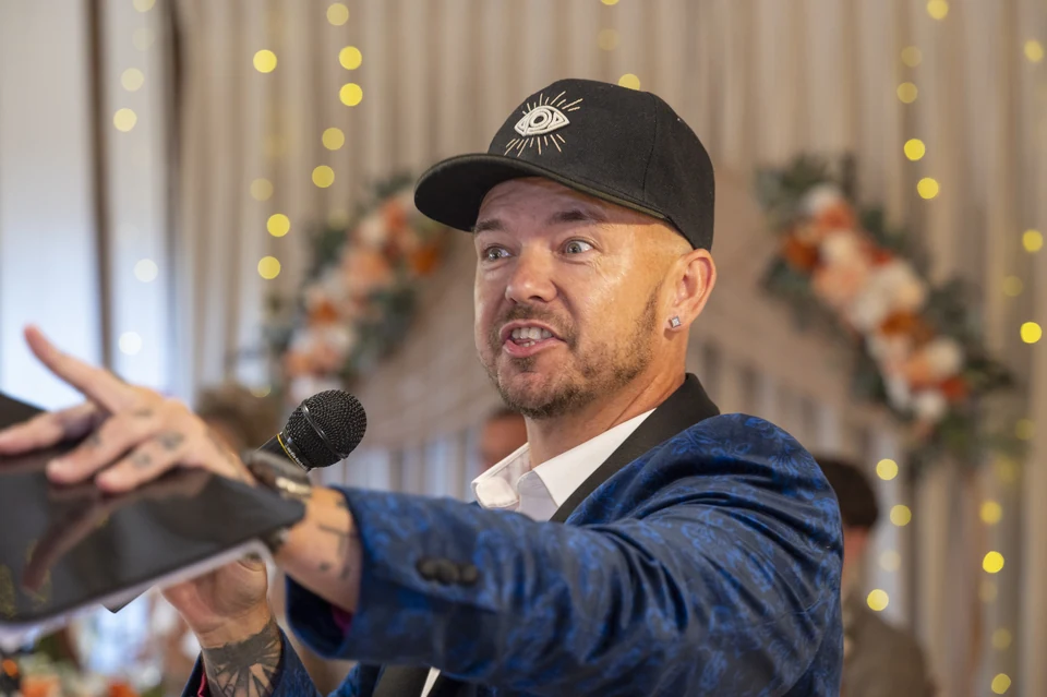 Phil Pearson speaking and performing at a wedding reception