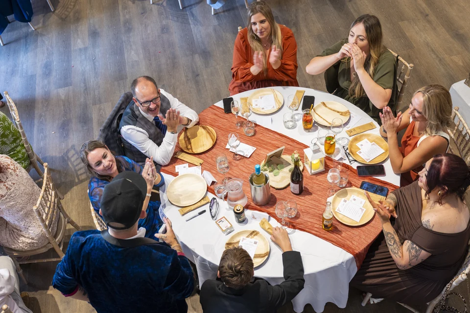 Top-down view of Phil Pearson performing table magic at a wedding